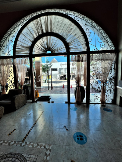 The spacious, step-free entrance has a seating area. There are hazard stripes on the floor.