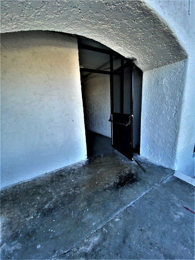 The emergency exit is open and the area is step-free and spacious.
