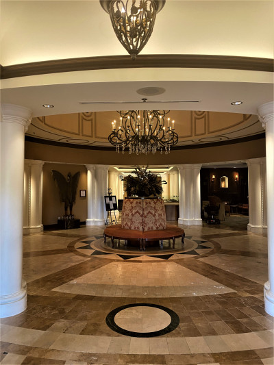 Inside the hotel, there is a circular, step-free hallway. There is a large, circular chair in the middle of the room.