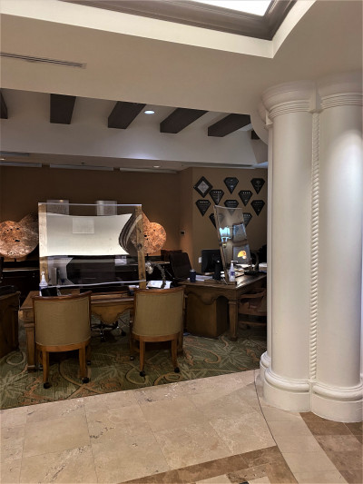 The reception area has 3, reception desks, with perspex screens and movable chairs.