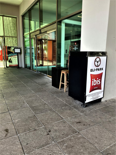 Access to the hotel is from a wide, step-free walkway and through a sliding, glass door.