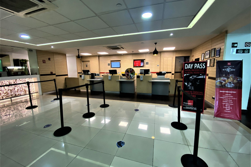The spacious reception area has 3 accessible check-in desks. There are also queue barriers.