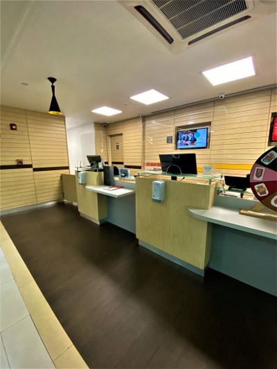 The spacious reception area has accessible check-in desks with plexiglass screen protection.