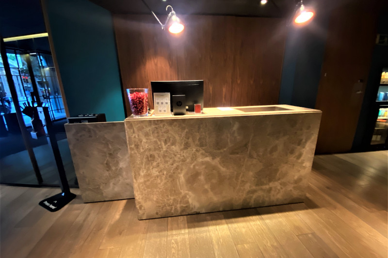 The spacious reception area has a high check-in desk.