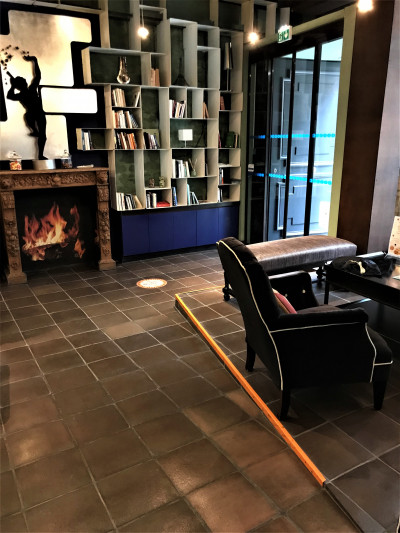 The lobby has a fireplace and a seating area. The area is step-free, with a ramp leading from the entrance.