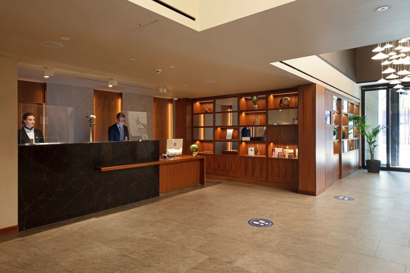 The spacious reception area has a high check-in desk with a lowered counter.