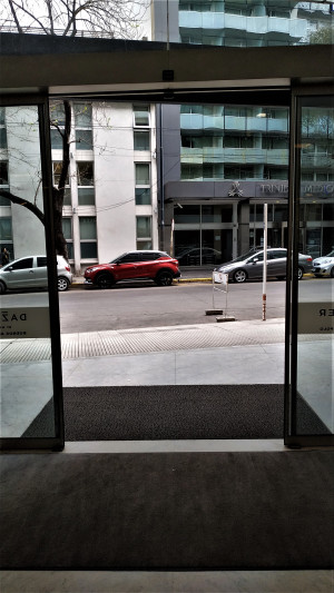 The sliding doors open onto the sidewalk.