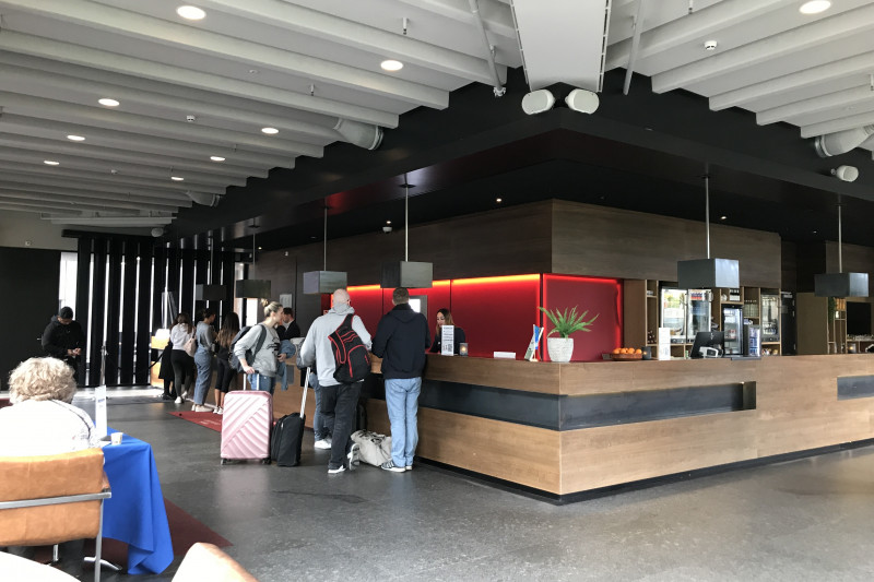 The spacious reception area has a high check-in desk.