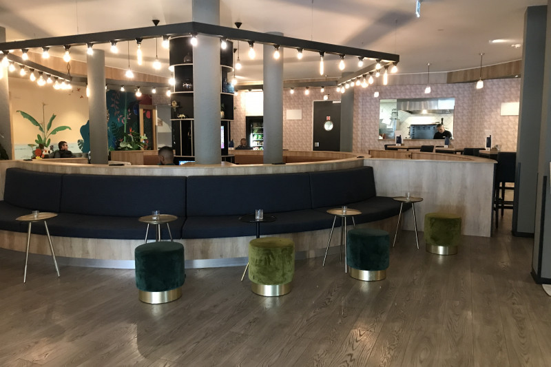 The spacious lounge bar has circular banquette seating with small moveable drinks tables and pouffes.