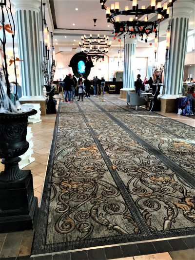 The spacious, carpeted lobby has assorted tables and chairs.