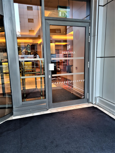 There is a manual glass door leading to the hotel lobby.
