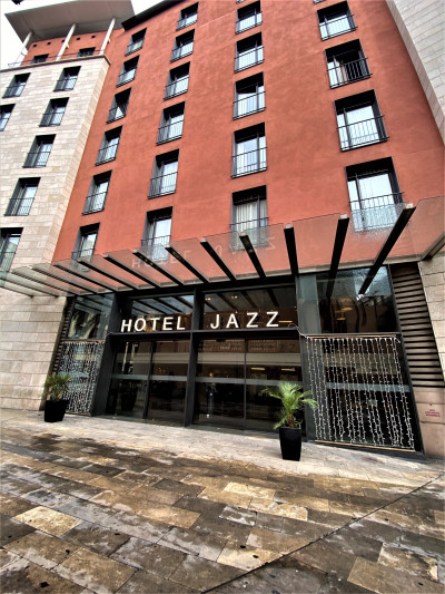 A photo of the hotel from the sidewalk. It is a modern 6 story, terrace building.