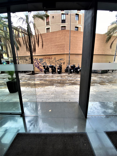 The hotel lobby has automatic doors that lead onto the sidewalk.