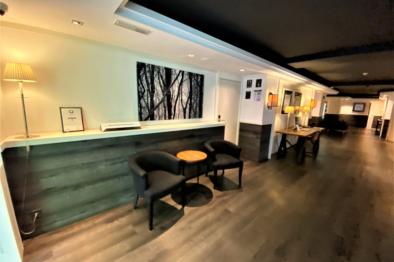 The spacious lobby has seating and a workstation with a movable chair.