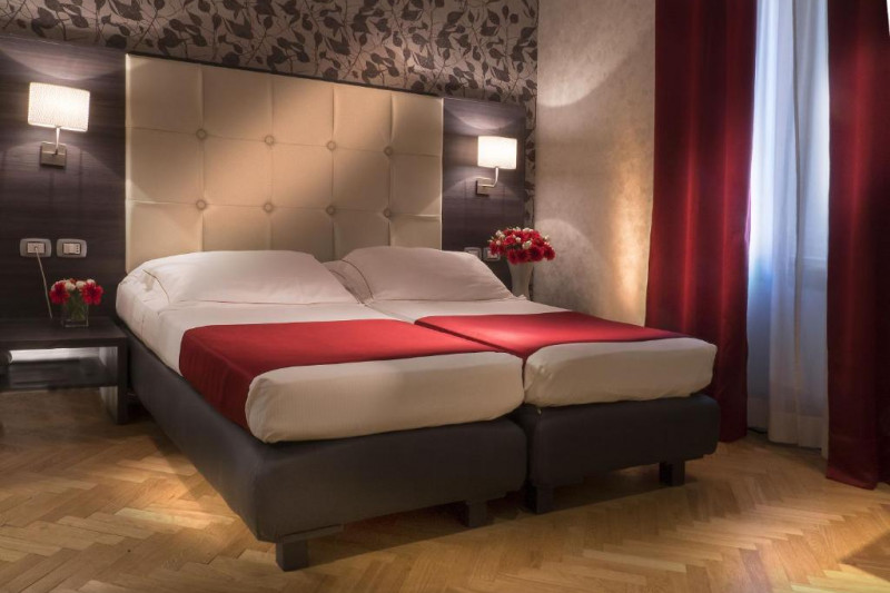 The spacious room has twin beds with nightstands and accessible plug sockets and light switches.