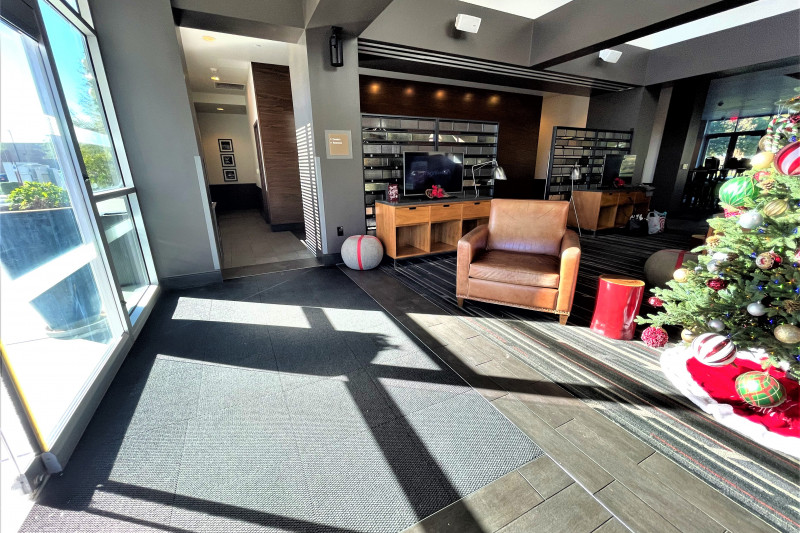 The spacious lobby has 2 TV screens, armchairs, and festive decorations.