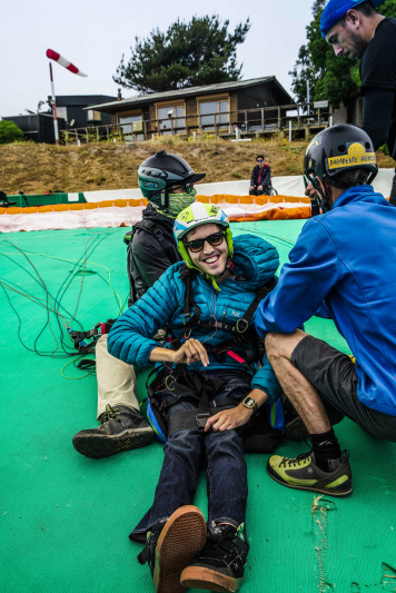 Traveler smiles after paragliding trip over Maitencillo.