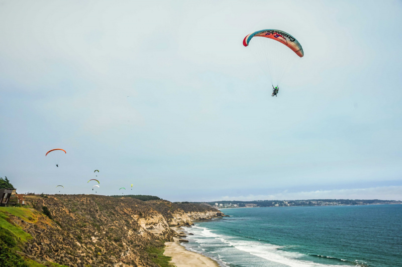 Multiple paragliders over Maitencillo.