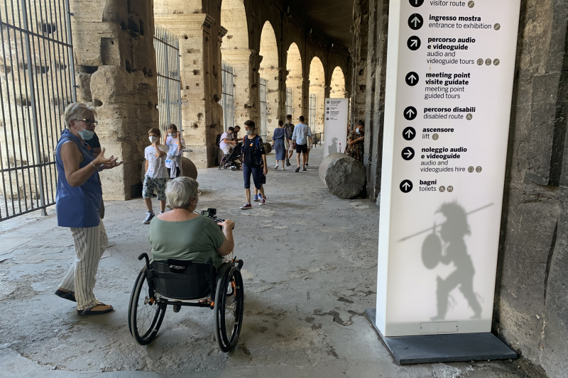 Woman on a wheelchair explores the Colosseum ruins