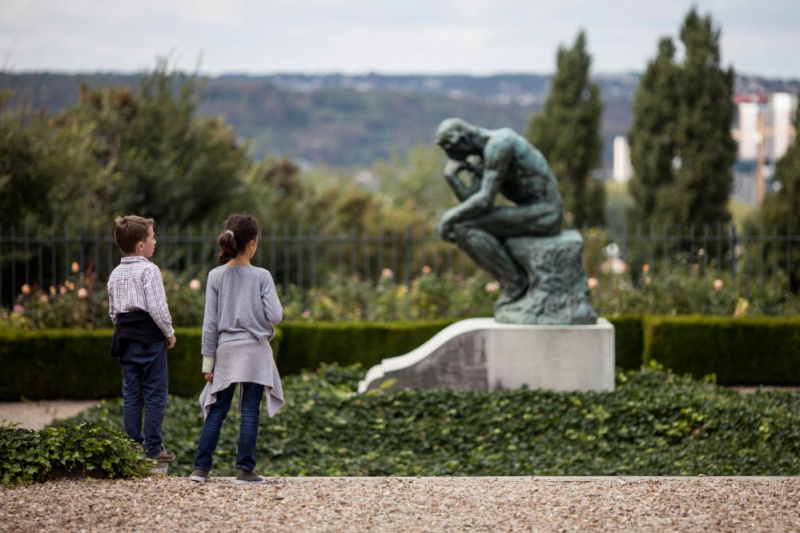 Children gaze at a sculpture in the garden