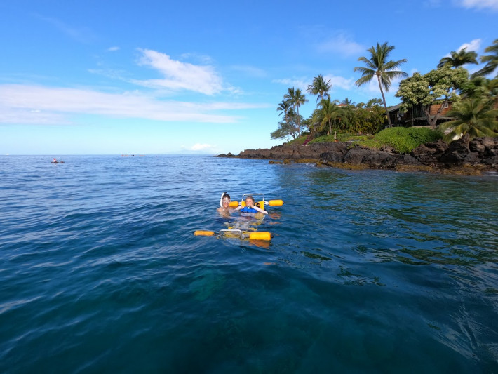 A wheelchair user is enjoying the snorkeling experience in Maui